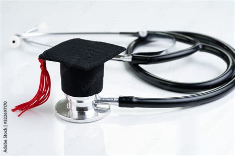 Graduation hat on doctor stethoscope, white background using as medical ...