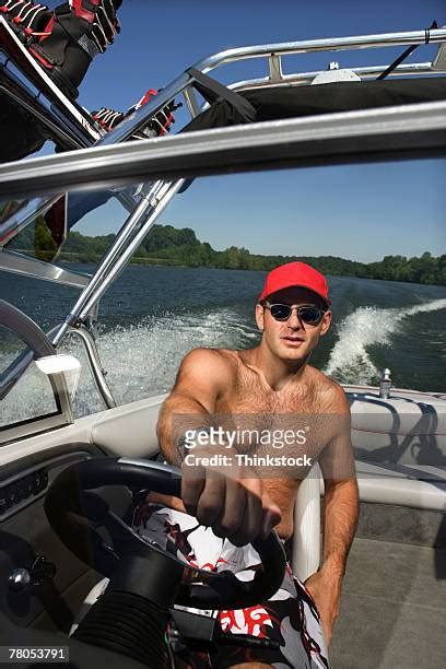 Man Driving Speed Boat Wearing White Outfit Photos And Premium High Res