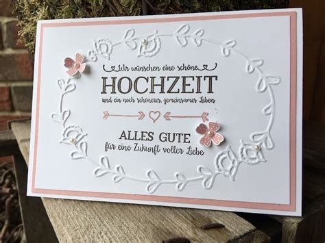 A White Card With Pink Flowers On It And The Words Hoochzeit Written In