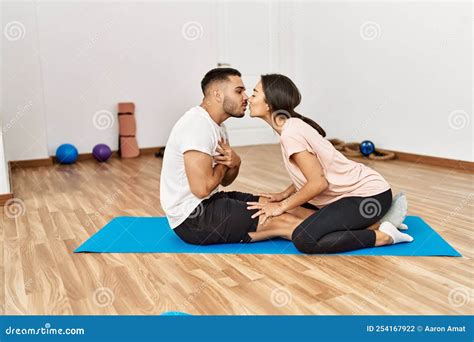 Latin Man And Woman Couple Kissing Training Abs Exercise At Sport