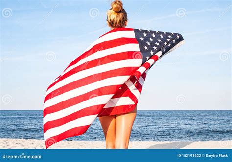 Beautiful Patriotic Woman With American Flag On The Beach Usa