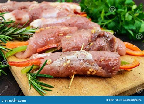 Un Cooked Pork Meat Rolls Stuffed With Vegetables Pepper Carrots In Hot Garlic Sauce On A