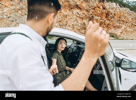 A Man Helps A Woman Get Out Of The Car He Gave Her His Hand For This