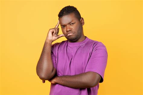 Thoughtful Displeased Black Guy Thinking Touching Head Over Yellow
