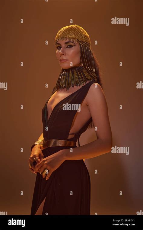 Beautiful Brunette Woman In Egyptian Costume And Headdress Looking At