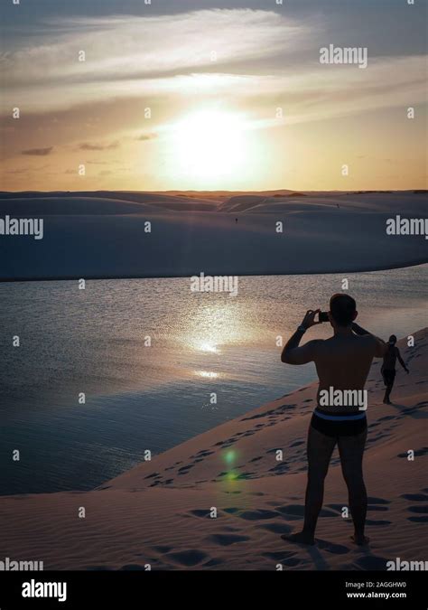 A Man Enjoying A Dusk View Among The Lagoons And Sand Dunes Of The