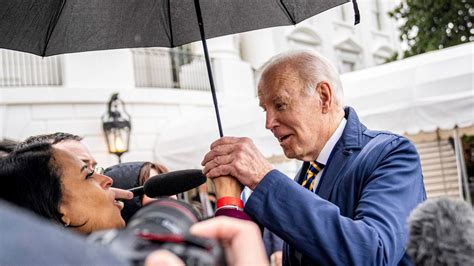 Biden Grabs Nbc Reporter S Hand As He Steps Underneath Her Umbrella To