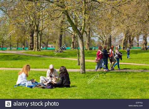 Group Of Young People Sitting On Grass In Londons Hyde Park On A Stock