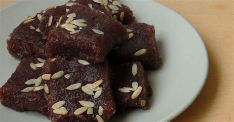 Some Brownies On A White Plate Topped With Oatmeal Toppings And Sliced