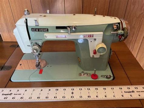 New Home Sewing Machine Cabinet And Accessories Legacy Auction Company