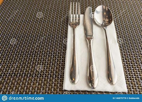 Spoon Fork And Knife On White Napkin On The Table Phuket Stock Photo