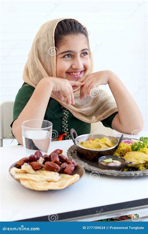 Adorable Smiling Pakistani Muslim Girl With Beautiful Eyes Resting Chin In Hands During Sitting