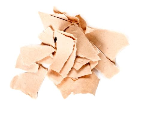 Premium Photo A Pile Of Torn Kraft Paper Is Isolated On A White