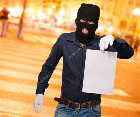 Man Wearing A Robber Mask Showing A Blank Paper — Stock Photo