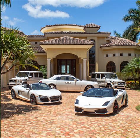 A Look At Some Mansions With Expensive Cars Parked In Front Homes Of