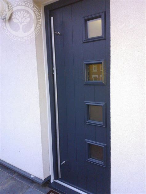 The Front Door Is Painted Blue And Has Two Side Panels On Each Side