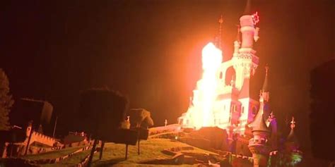 disney castle    flames fire engulfs structure