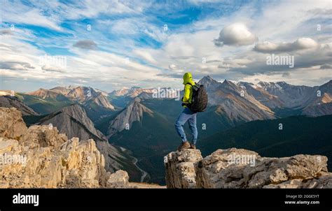 Hiker Standing On A Rock Mountain Landscape With River Valley And