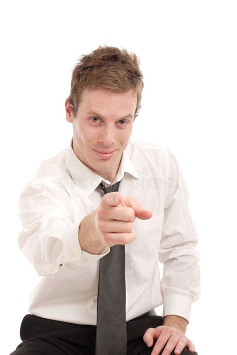 A Man In A White Shirt And Black Tie Pointing At The Camera With His Finger