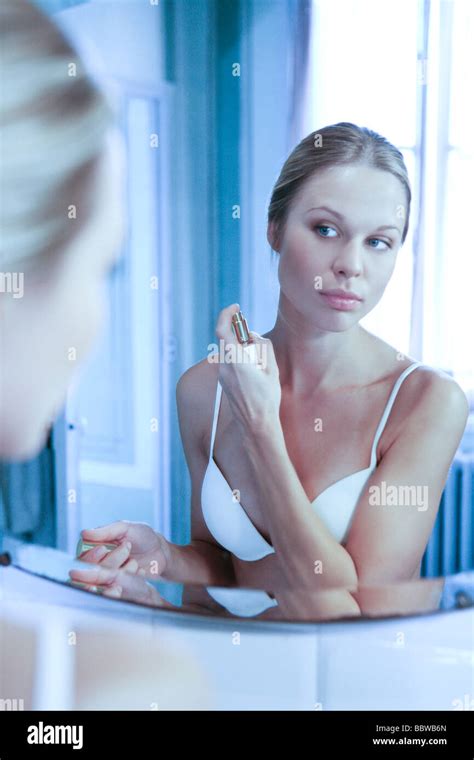 young woman spraying perfume on neck Stock Photo - Alamy