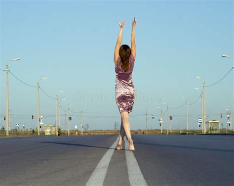 Ragazza Nella Camminata Del Vestito A Piedi Nudi Sulla Strada Vuota