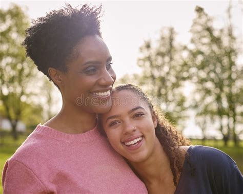 Loving Mature Mother With Teenage Daughter Enjoying Walk In Countryside Together Stock Photo