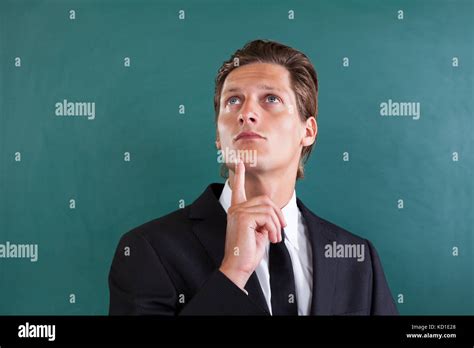 Portrait Of Young Thoughtful Businessman Looking Up Stock Photo Alamy