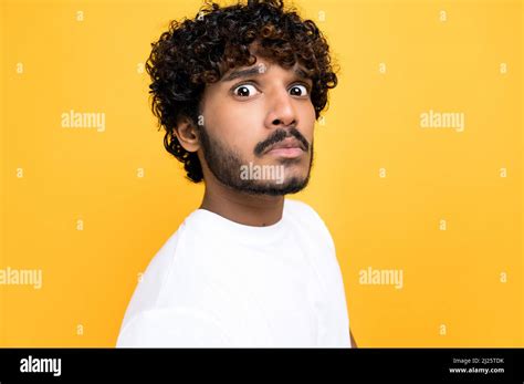 Close Up Photo Of A Scared Confused Indian Or Arabian Curly Haired Guy