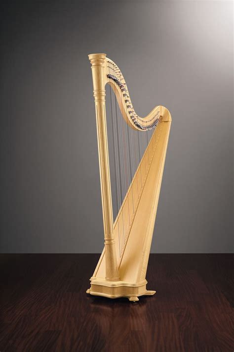 A Golden Harp Sitting On Top Of A Wooden Table