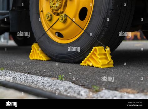 Tire Stopper Yellow Plastic With A Rope Stock Photo Alamy