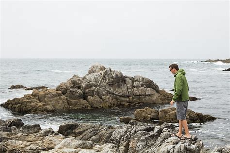 Man Walking On Rocks In The Pacific Ocean By Stocksy Contributor Amy