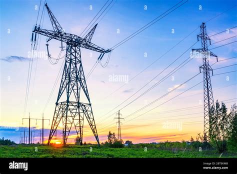 Industrial Landscape With High Voltage Power Lines At The Sunset Stock