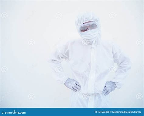 Doctor Or Scientist In Ppe Suite Uniform Showing Hands On Waist Over