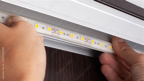 installation of decorative LED .diode strip mounting Stock Photo | Adobe Stock