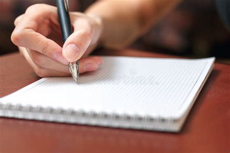 Female Hand Holding A Pen And Writing In A Notebook Stock Image Image