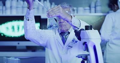 Mature Laboratory Scientist Testing Phenolphthalein Chemical Reaction