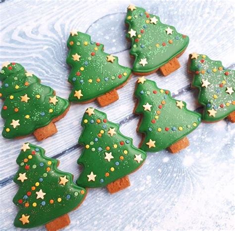 Decorated Cookies With Green Icing And Gold Stars On Them Are Arranged