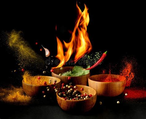 Hot Spices And Seasonings Powder Splash Explosion On Black Background With Flame Stock Photo