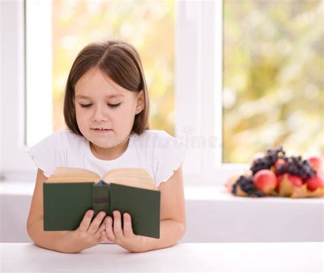 La Petite Fille Lit Un Livre Image Stock Image Du Livre Brune 36850497