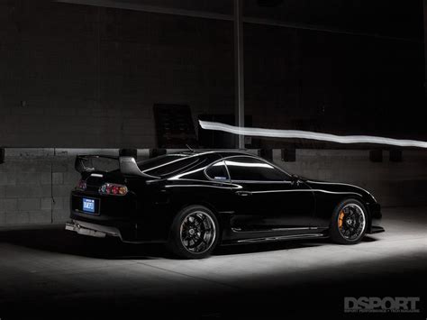 A Black Sports Car Parked In The Dark