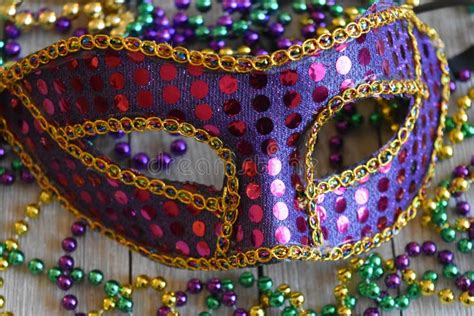 Mardi Gras Mask with Beads on a Wood Background Stock Photo - Image of ...