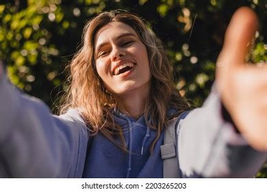 Happy Satisfied Curly Blonde Girl Gives Stock Photo
