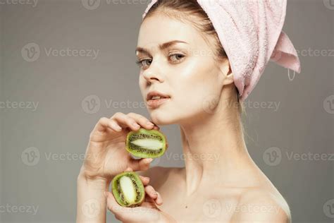 Woman Naked Shoulders Towel On Head Clean Skin Kiwi In Hands Stock Photo At Vecteezy