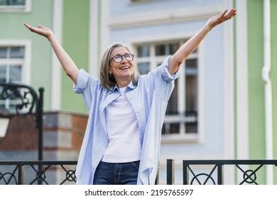 Happy Excited Mature Woman Hands Lifted Stock Photo