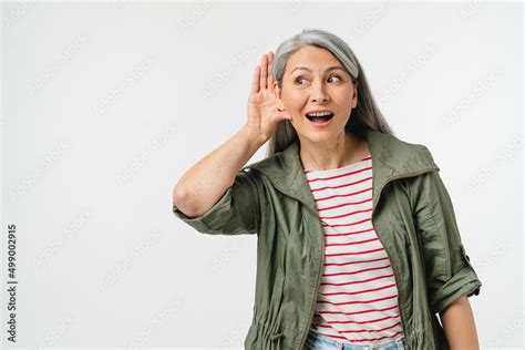 Curious Mature Middle Aged Woman Pricking Up Her Ears Listening To Gossips Rumors Hand To Ear
