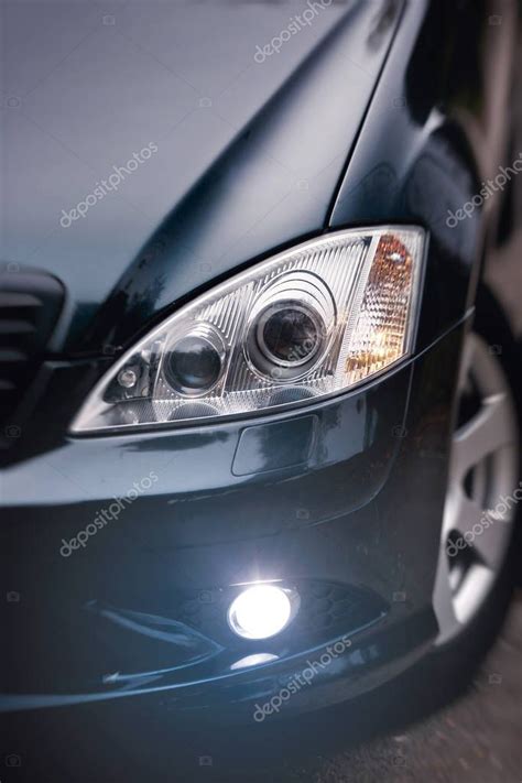 Headlights of dark blue car. — Stock Photo © Kucheruk #130104794