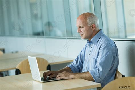 Mature Businessman Working On Laptop Stock Photo 2156277 Crushpixel
