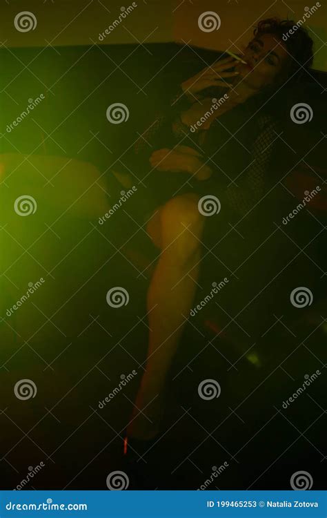 Woman Wearing Black Lingerie Sitting On The Sofa In Green Light Stock Image Image Of Celebrate