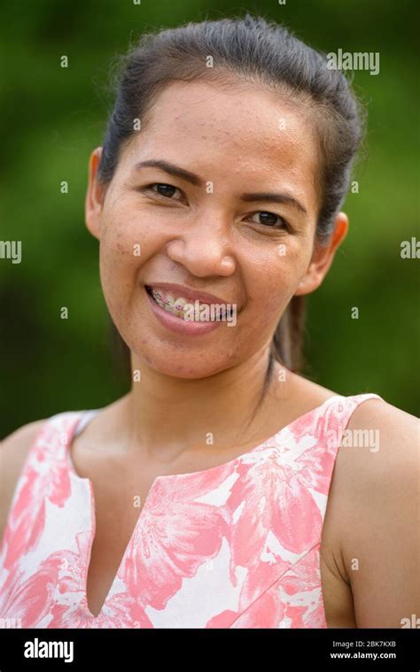 Happy Mature Asian Woman Relaxing At The Park Outdoors Stock Photo Alamy