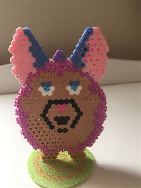 An Animal Made Out Of Plastic Beads Sitting On Top Of A Table